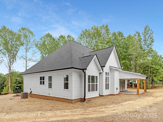 4032 Brandy Creek Ct, Clover, SC 29710 - view of home's exterior with roof with shingles, dirt driveway, a carport, and a patio area
