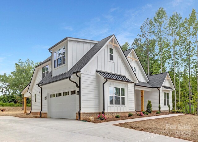 4032 Brandy Creek Ct, Clover, SC 29710 - modern farmhouse style home with a garage, concrete driveway, board and batten siding, roof with shingles, and a standing seam roof