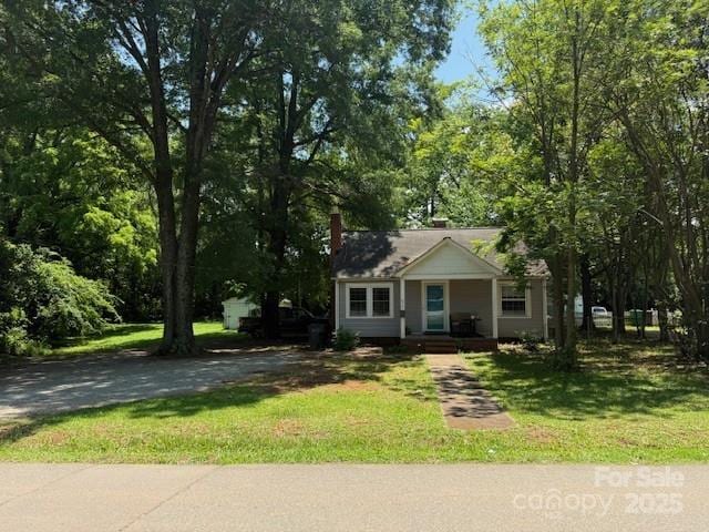 917 Tennyson Dr, Charlotte, NC 28208 - view of front of home featuring a front yard, a chimney, and covered porch