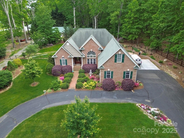 2400 Saint John Rd, East Bend, NC 27018 - view of front of home with asphalt driveway, brick siding, and a view of trees