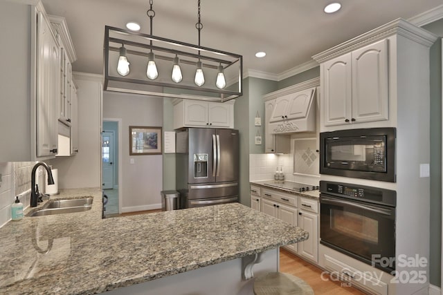 2400 Saint John Rd, East Bend, NC 27018 - kitchen with black appliances, a peninsula, decorative backsplash, light stone counters, and ornamental molding