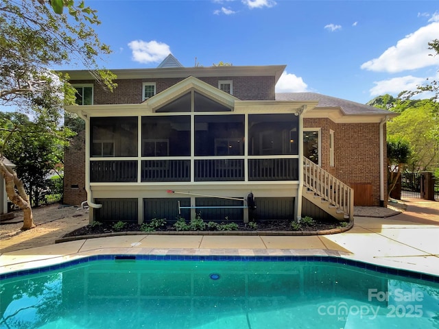 2027 Brook View Ct, Matthews, NC 28104 - back of property featuring brick siding, a sunroom, an outdoor pool, and stairway