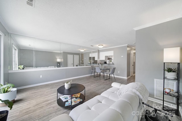 502 Heritage Pkwy, Fort Mill, SC 29715 - living room with a textured ceiling, wood finished floors, and crown molding