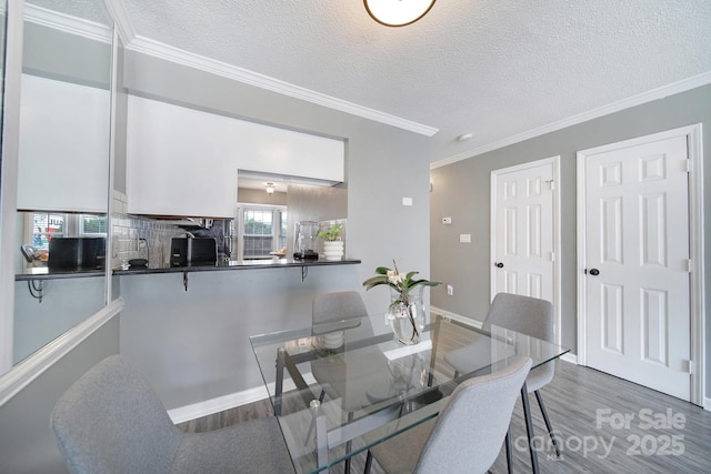 502 Heritage Pkwy, Fort Mill, SC 29715 - dining area featuring a textured ceiling, wood finished floors, and crown molding