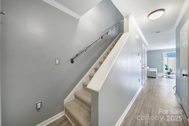 502 Heritage Pkwy, Fort Mill, SC 29715 - stairs featuring a textured ceiling, ornamental molding, and wood finished floors