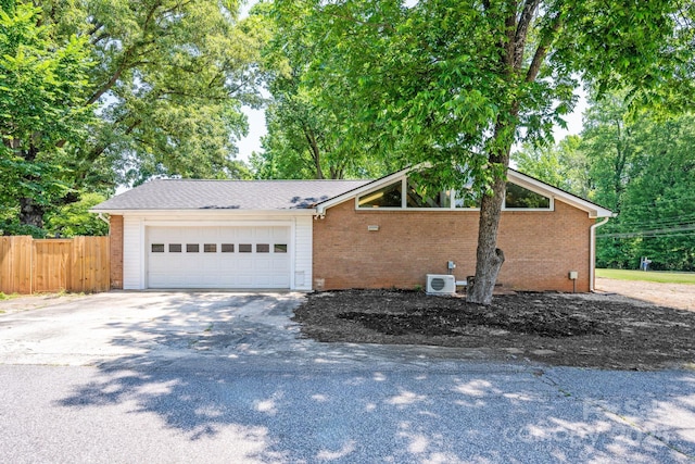 318 W Peeler St, Salisbury, NC 28146 - view of front of home featuring brick siding, driveway, and an attached garage