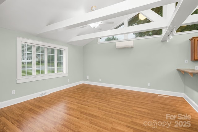 318 W Peeler St, Salisbury, NC 28146 - basement featuring a wall unit AC, light wood-style flooring, and a ceiling fan