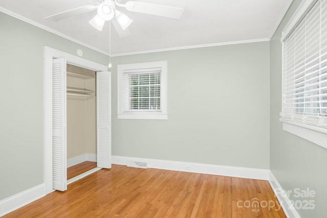 318 W Peeler St, Salisbury, NC 28146 - unfurnished bedroom featuring wood finished floors, crown molding, a closet, and ceiling fan