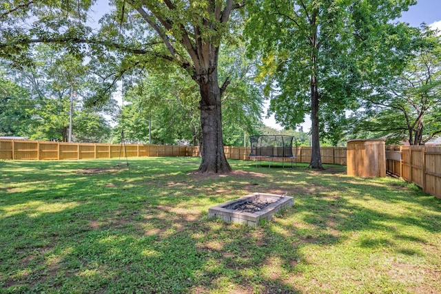 318 W Peeler St, Salisbury, NC 28146 - fenced backyard featuring a trampoline and a storage unit