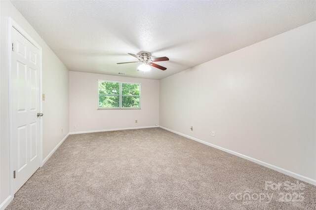 7008 Wannamaker Ln, Charlotte, NC 28226 - unfurnished room with ceiling fan, light colored carpet, and a textured ceiling