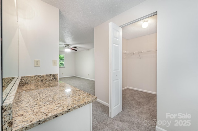 7008 Wannamaker Ln, Charlotte, NC 28226 - interior space with a textured ceiling, ceiling fan, light colored carpet, and light stone countertops