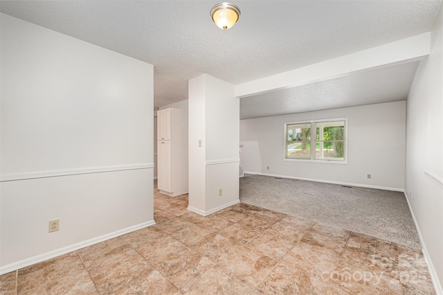 7008 Wannamaker Ln, Charlotte, NC 28226 - carpeted empty room featuring a textured ceiling and tile patterned flooring