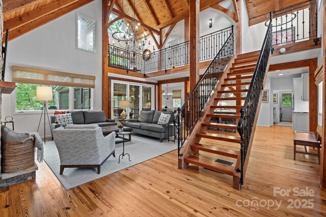 891 Crescent Trl Unit 273, Highlands, NC 28741 - living room featuring high vaulted ceiling, hardwood / wood-style flooring, stairway, a chandelier, and a wood ceiling with exposed beams