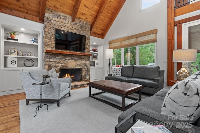 891 Crescent Trl Unit 273, Highlands, NC 28741 - living area featuring wood finished floors, a wood ceiling with exposed beams, high vaulted ceiling, built in shelves, and a stone fireplace