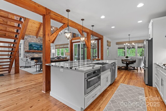 891 Crescent Trl Unit 273, Highlands, NC 28741 - kitchen featuring a chandelier, appliances with stainless steel finishes, white cabinets, light stone countertops, and recessed lighting
