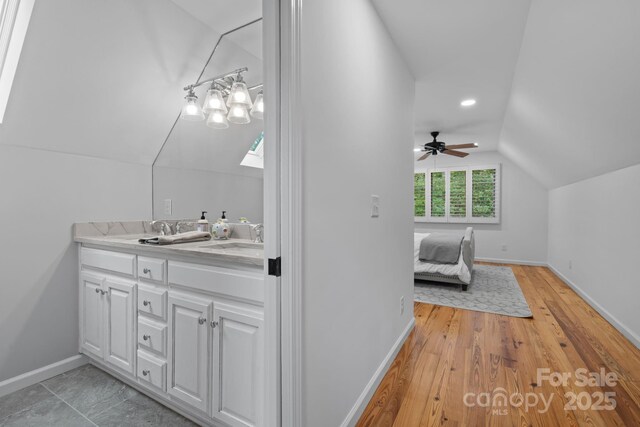 891 Crescent Trl Unit 273, Highlands, NC 28741 - bathroom featuring lofted ceiling, double vanity, ceiling fan, wood finished floors, and recessed lighting