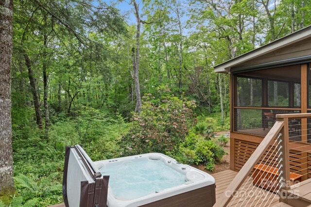 891 Crescent Trl Unit 273, Highlands, NC 28741 - deck featuring a hot tub, a sunroom, stairs, and a view of trees