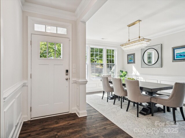 1008 Millbridge Pkwy, Waxhaw, NC 28173 - entrance foyer featuring a decorative wall, dark wood-style floors, crown molding, and wainscoting