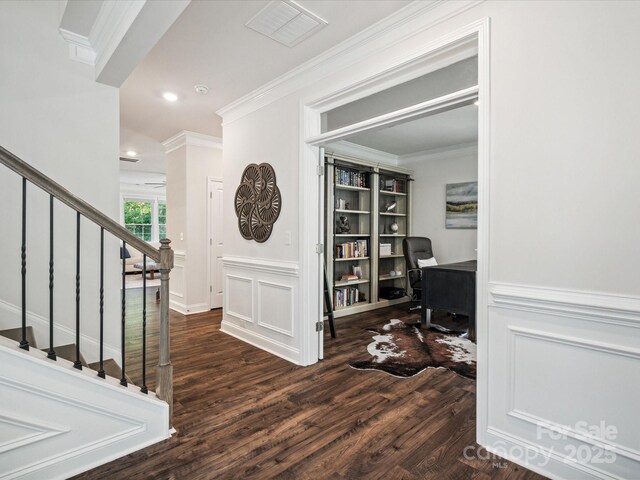 1008 Millbridge Pkwy, Waxhaw, NC 28173 - foyer entrance with ornamental molding, wood finished floors, a decorative wall, stairs, and a wainscoted wall
