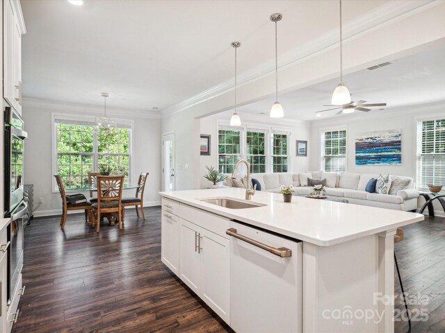 1008 Millbridge Pkwy, Waxhaw, NC 28173 - kitchen with dishwasher, crown molding, dark wood-style floors, an island with sink, and light countertops