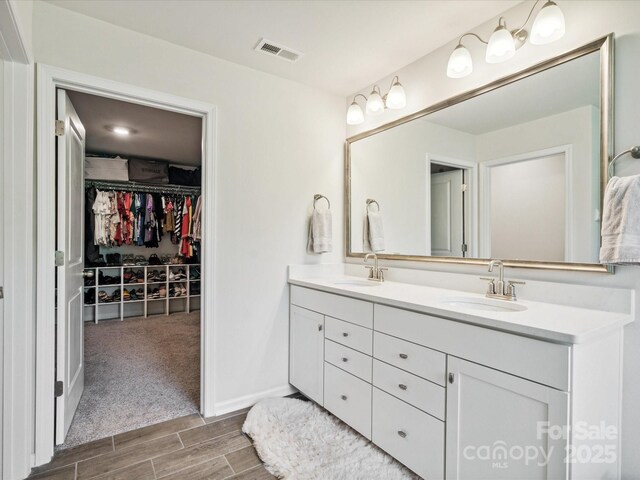 1008 Millbridge Pkwy, Waxhaw, NC 28173 - full bathroom featuring double vanity, wood tiled floors, and a walk in closet