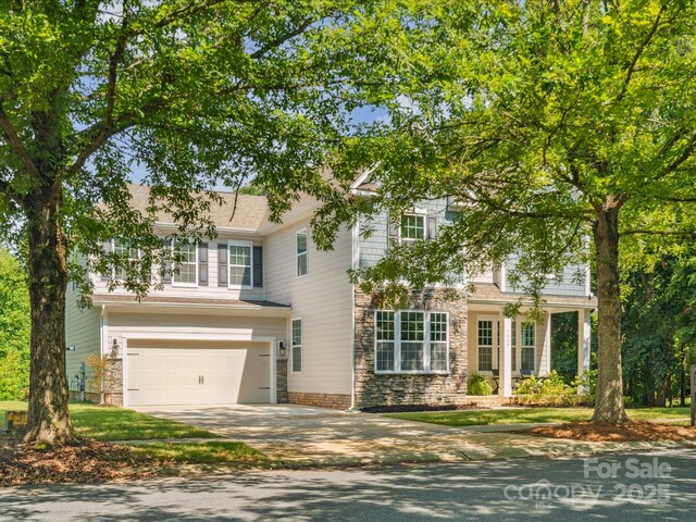 1008 Millbridge Pkwy, Waxhaw, NC 28173 - view of front facade with a garage, driveway, and stone siding