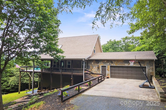 3381 Stones Throw Dr, Valdese, NC 28690 - view of front of property with stone siding, an attached garage, roof with shingles, concrete driveway, and a wooden deck