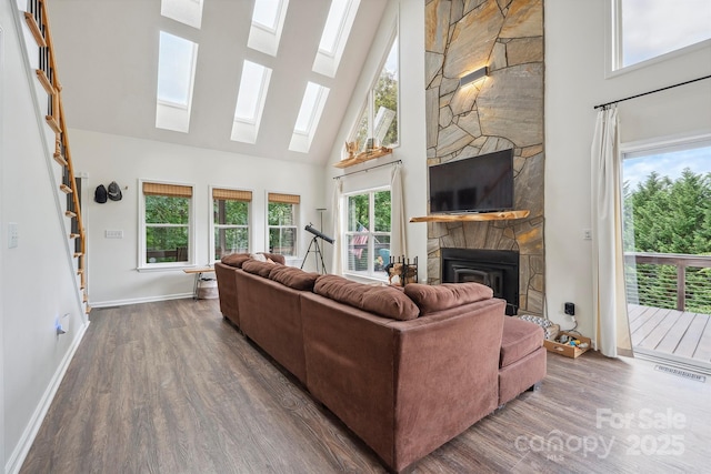 3381 Stones Throw Dr, Valdese, NC 28690 - living room with a high ceiling, wood finished floors, a skylight, and a stone fireplace