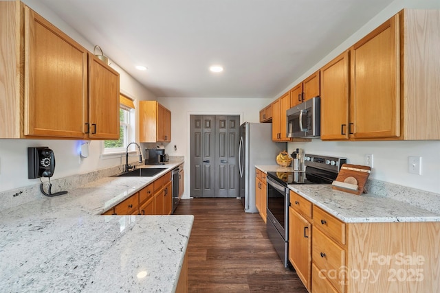 3381 Stones Throw Dr, Valdese, NC 28690 - kitchen featuring appliances with stainless steel finishes, light stone countertops, dark wood finished floors, recessed lighting, and brown cabinets