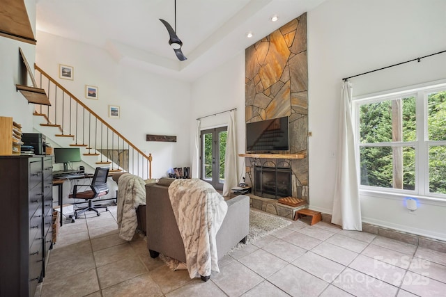 3381 Stones Throw Dr, Valdese, NC 28690 - living area featuring a towering ceiling, plenty of natural light, a stone fireplace, stairway, and light tile patterned floors