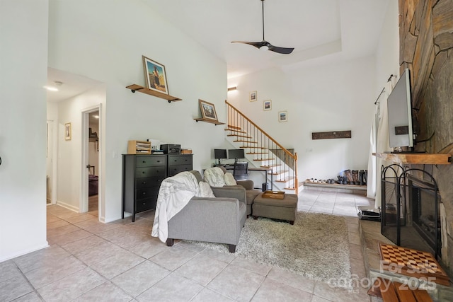 3381 Stones Throw Dr, Valdese, NC 28690 - living area with a high ceiling, stairway, light tile patterned flooring, a ceiling fan, and a fireplace