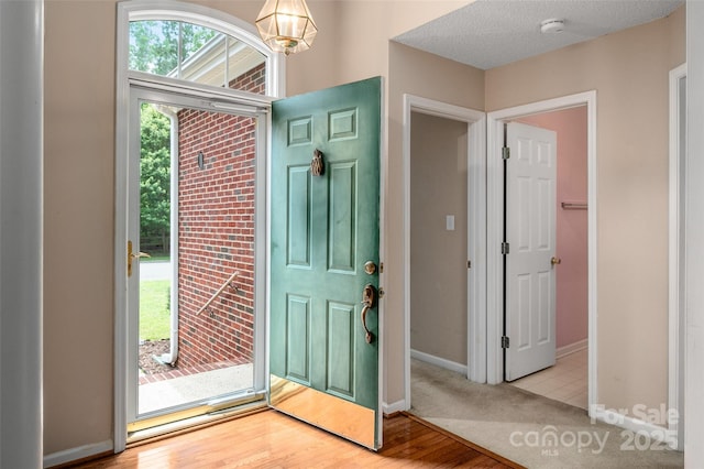8002 Kingston Dr, Waxhaw, NC 28173 - foyer featuring a chandelier and wood finished floors