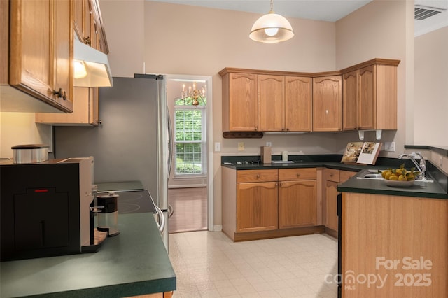 8002 Kingston Dr, Waxhaw, NC 28173 - kitchen featuring dark countertops, under cabinet range hood, and pendant lighting