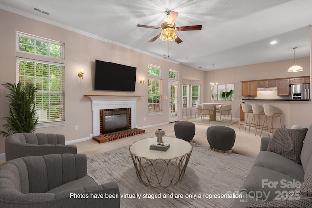 8002 Kingston Dr, Waxhaw, NC 28173 - living area with light colored carpet, a ceiling fan, plenty of natural light, a fireplace, and crown molding