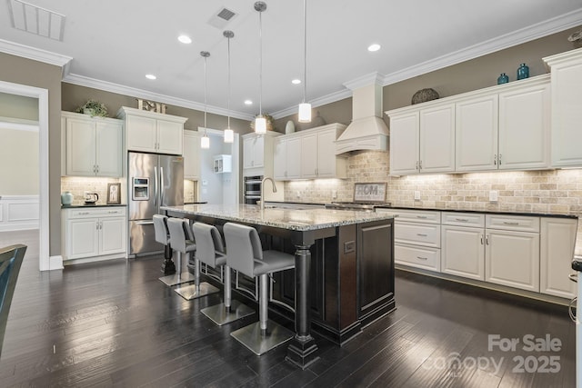 426 Kirkbride Ct, Fort Mill, SC 29715 - kitchen featuring stainless steel fridge with ice dispenser, custom exhaust hood, a kitchen bar, decorative light fixtures, and tasteful backsplash
