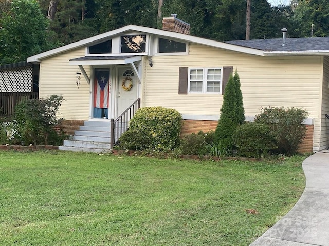 1010 Sprucewood St, Kannapolis, NC 28081 - view of front of house with a front lawn, a chimney, and brick siding