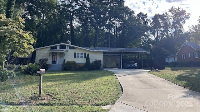 1010 Sprucewood St, Kannapolis, NC 28081 - ranch-style home featuring a front lawn, concrete driveway, and an attached carport
