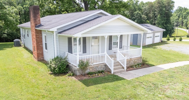 4879 Denton Chapel Rd, Morganton, NC 28655 - view of front of home with a chimney, a porch, a front lawn, and a shingled roof