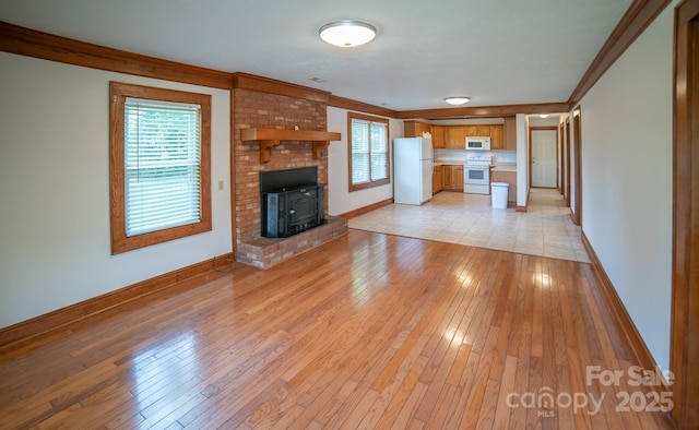 4879 Denton Chapel Rd, Morganton, NC 28655 - unfurnished living room with crown molding and light wood-style flooring
