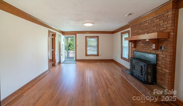 4879 Denton Chapel Rd, Morganton, NC 28655 - unfurnished living room featuring wood-type flooring, crown molding, and a textured ceiling