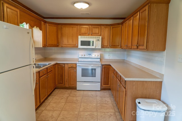 4879 Denton Chapel Rd, Morganton, NC 28655 - kitchen with white appliances, brown cabinetry, and crown molding
