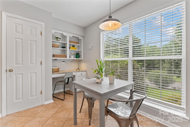 10043 Elsenham Ln, Charlotte, NC 28269 - dining space featuring a desk, healthy amount of natural light, a textured ceiling, and light tile patterned floors
