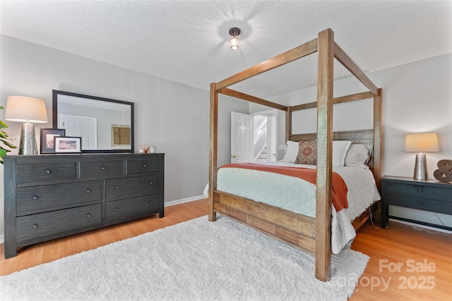 10043 Elsenham Ln, Charlotte, NC 28269 - bedroom featuring wood finished floors and a textured ceiling