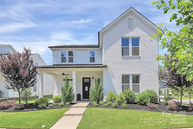 5129 Whitman Ave, Matthews, NC 28105 - view of front facade with a standing seam roof, a front yard, board and batten siding, a metal roof, and a porch