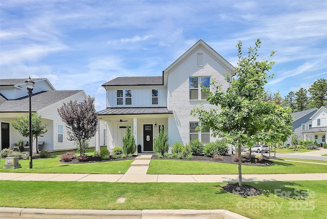 5129 Whitman Ave, Matthews, NC 28105 - view of front facade with a standing seam roof, board and batten siding, a front yard, a metal roof, and a porch