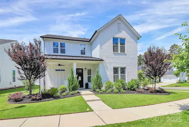 5129 Whitman Ave, Matthews, NC 28105 - view of front of property featuring a standing seam roof, board and batten siding, a front lawn, a porch, and a metal roof