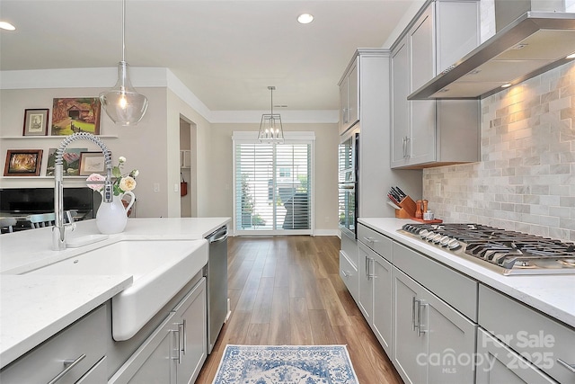 5129 Whitman Ave, Matthews, NC 28105 - kitchen with wall chimney range hood, appliances with stainless steel finishes, light wood finished floors, tasteful backsplash, and recessed lighting