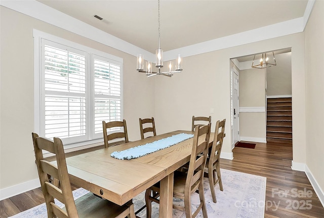 5129 Whitman Ave, Matthews, NC 28105 - dining room with a chandelier, dark wood-type flooring, and stairs