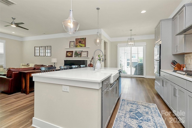 5129 Whitman Ave, Matthews, NC 28105 - kitchen featuring gray cabinetry, open floor plan, light countertops, recessed lighting, and ornamental molding