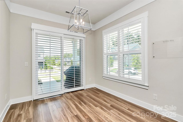 5129 Whitman Ave, Matthews, NC 28105 - unfurnished dining area with plenty of natural light, wood finished floors, and a chandelier